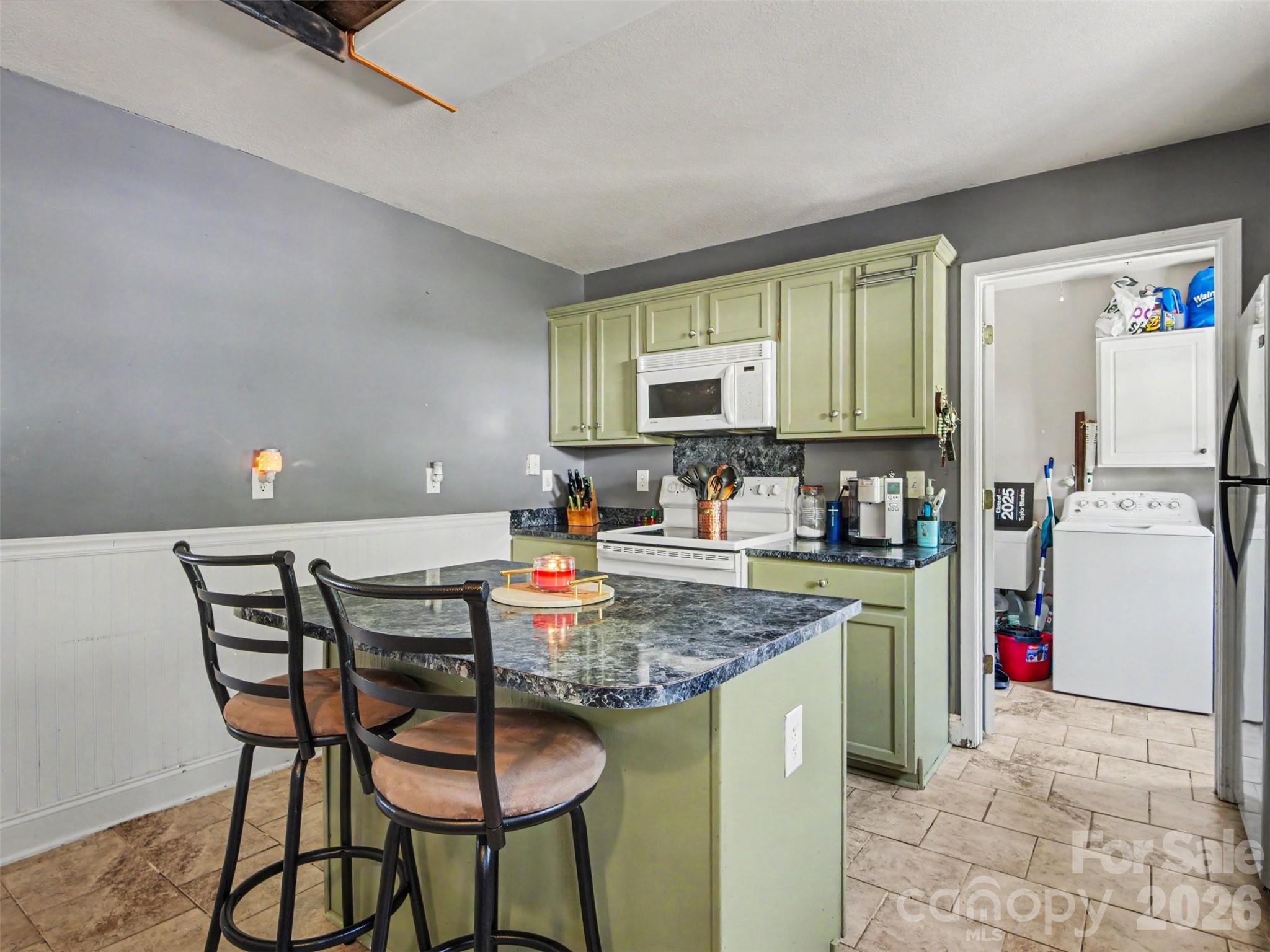 539 Brawley Road Cleveland, NC 27013 - Photo 10 of 41 a kitchen with stainless steel appliances granite countertop a table chairs sink and cabinets