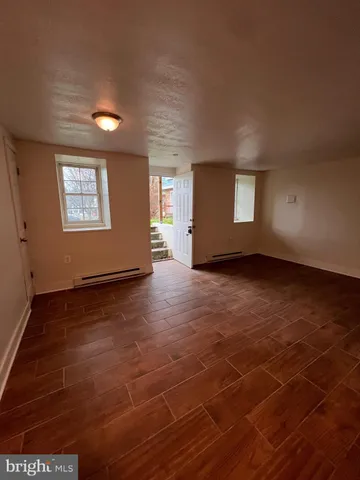 an empty room with windows and entrance