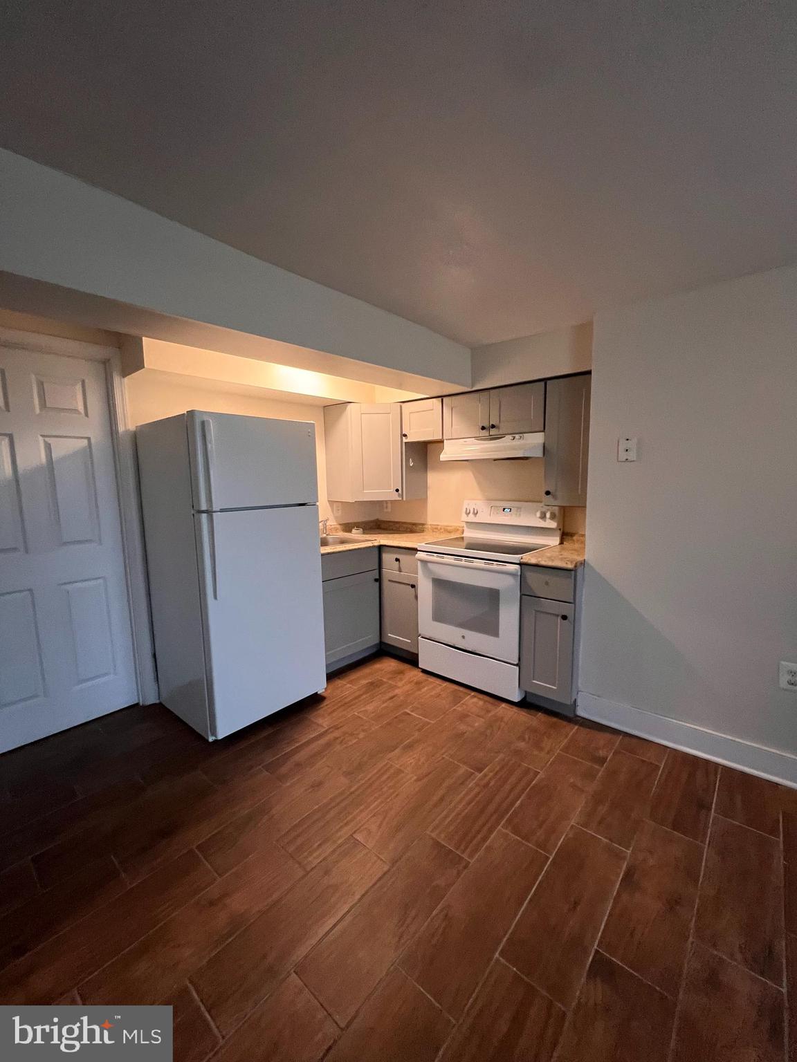400 East Washington Street, Unit 1 Charles Town, WV 25414 - Photo 4 of 9 a kitchen with a cabinets and wooden floor