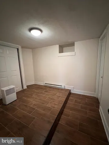 an empty room with wooden floor