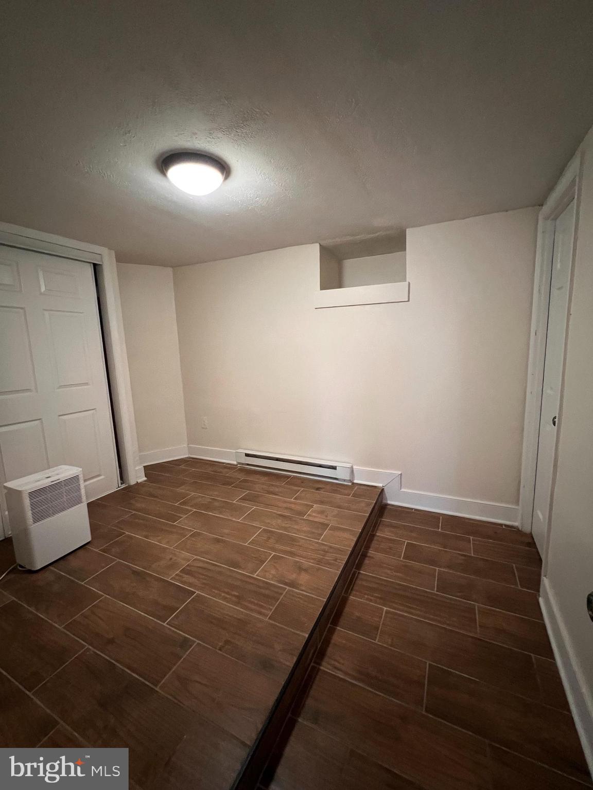 400 East Washington Street, Unit 1 Charles Town, WV 25414 - Photo 7 of 9 an empty room with wooden floor