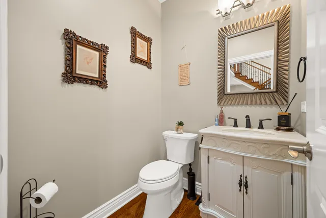 a white toilet sitting next to a bathroom sink