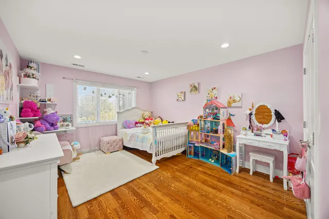 a bedroom with furniture and a wooden floor