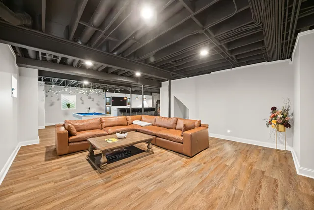 a living room with furniture and a wooden floor