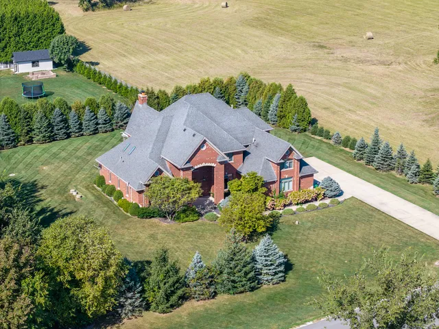 an aerial view of residential houses with outdoor space and ocean view