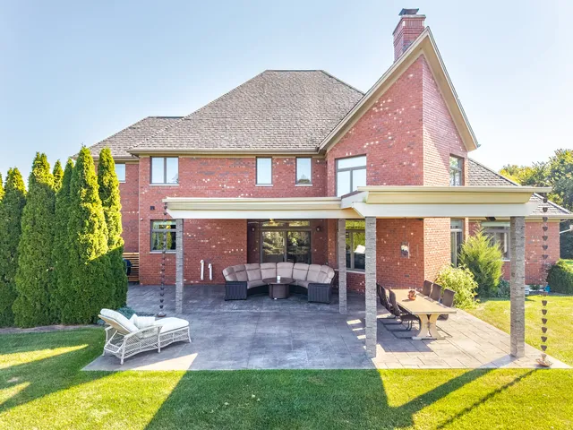 a view of a house with backyard porch and sitting area