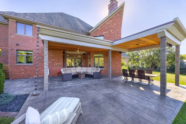 a view of a patio with a table and chairs under an umbrella