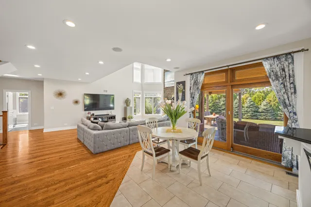 a living room with fireplace furniture and a large window
