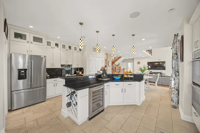 a kitchen with stainless steel appliances granite countertop a refrigerator and a sink