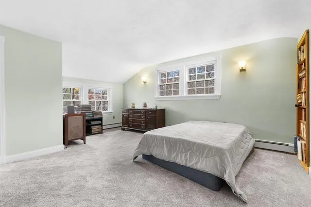 a bedroom with a bed and dresser