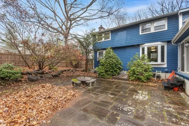 a backyard of a house with outdoor seating