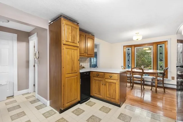 a kitchen with stainless steel appliances granite countertop a refrigerator and wooden cabinets
