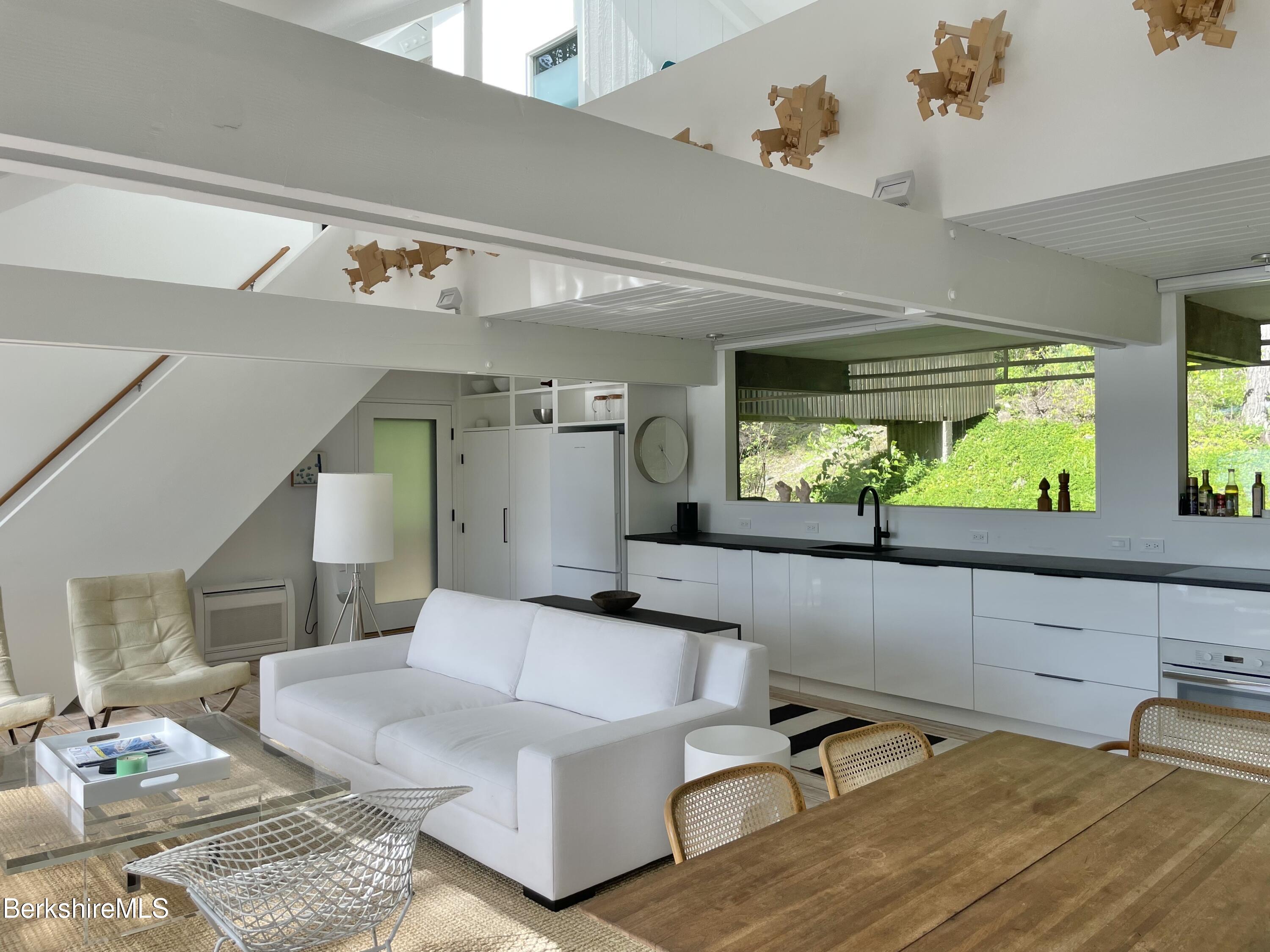 36 Elephant Rock Road Monterey, MA 01245 - Photo 11 of 30 a living room with patio furniture and a large window