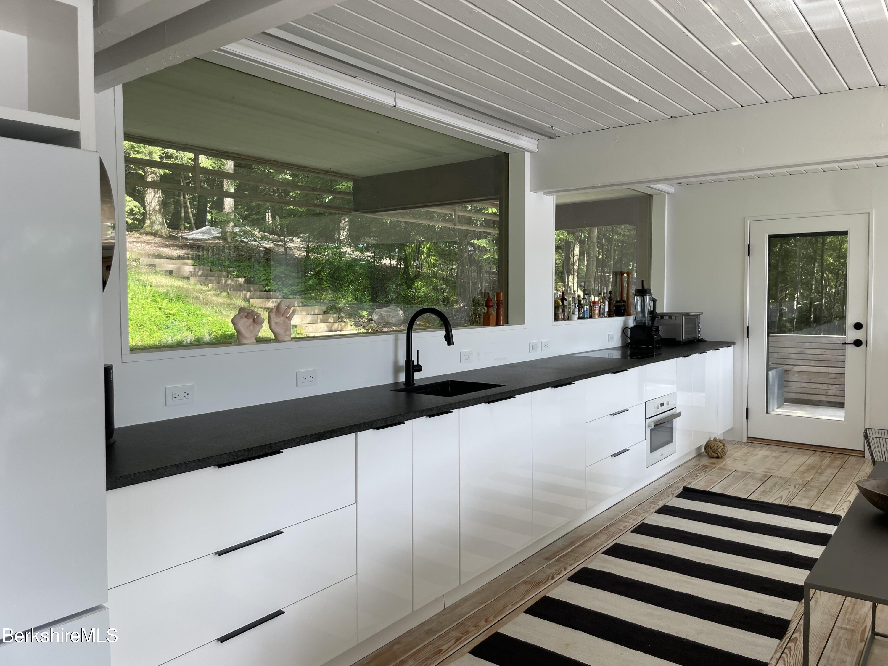 36 Elephant Rock Road Monterey, MA 01245 - Photo 14 of 30 a large white kitchen with a large window