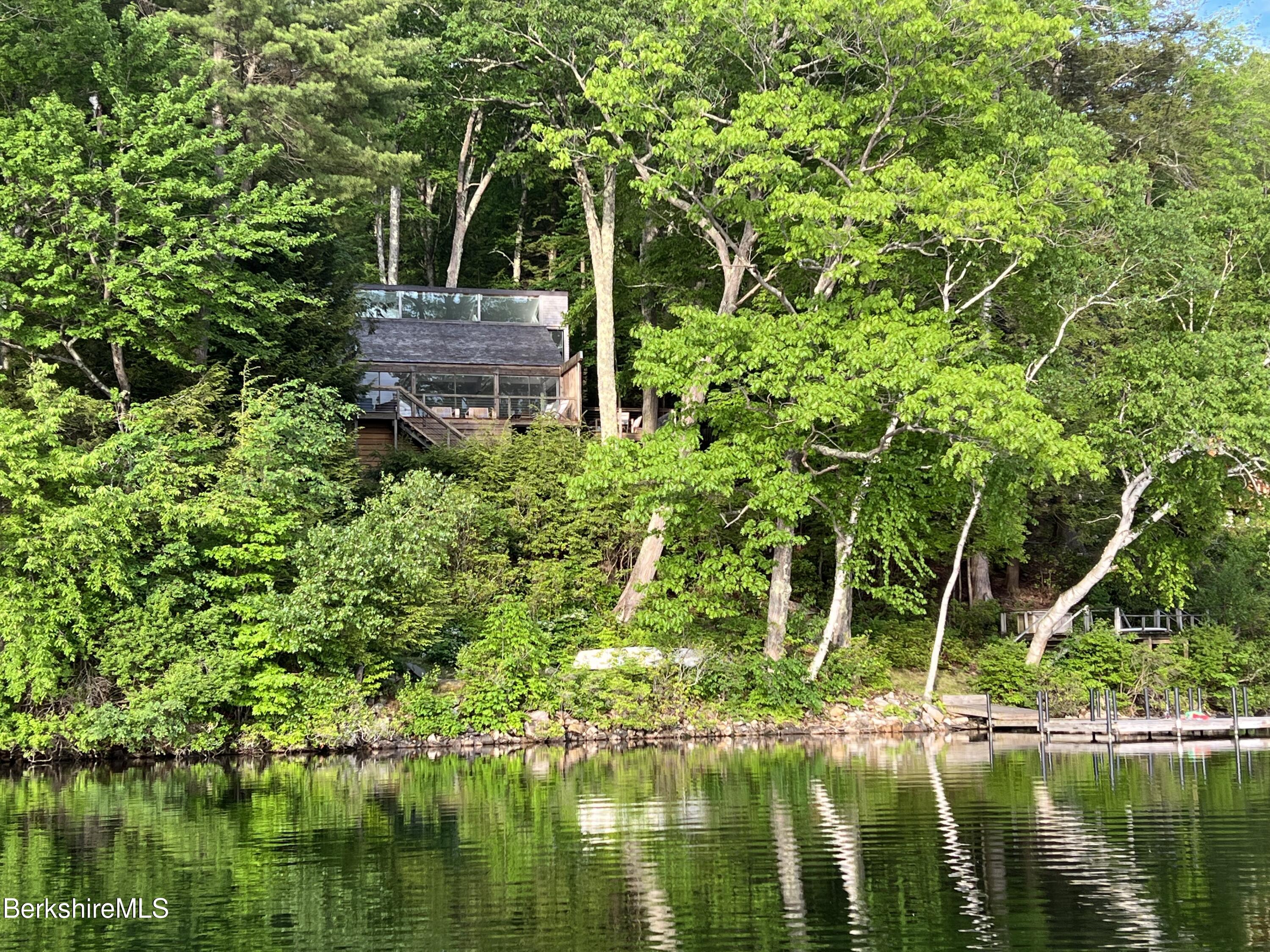 36 Elephant Rock Road Monterey, MA 01245 - Photo 2 of 30 a backyard of a house with lots of green space and lake view