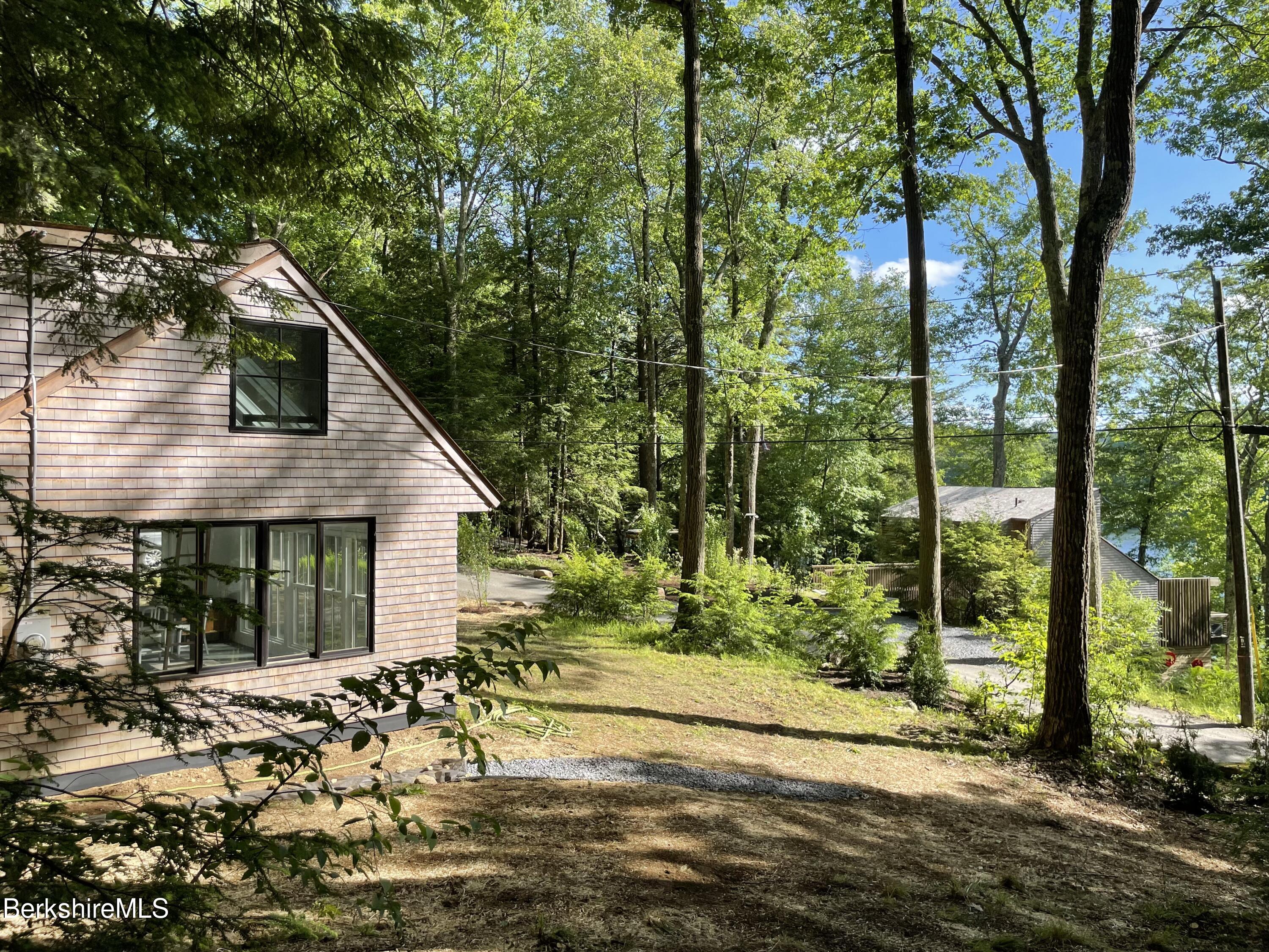 36 Elephant Rock Road Monterey, MA 01245 - Photo 26 of 30 a backyard of a house with large trees and plants