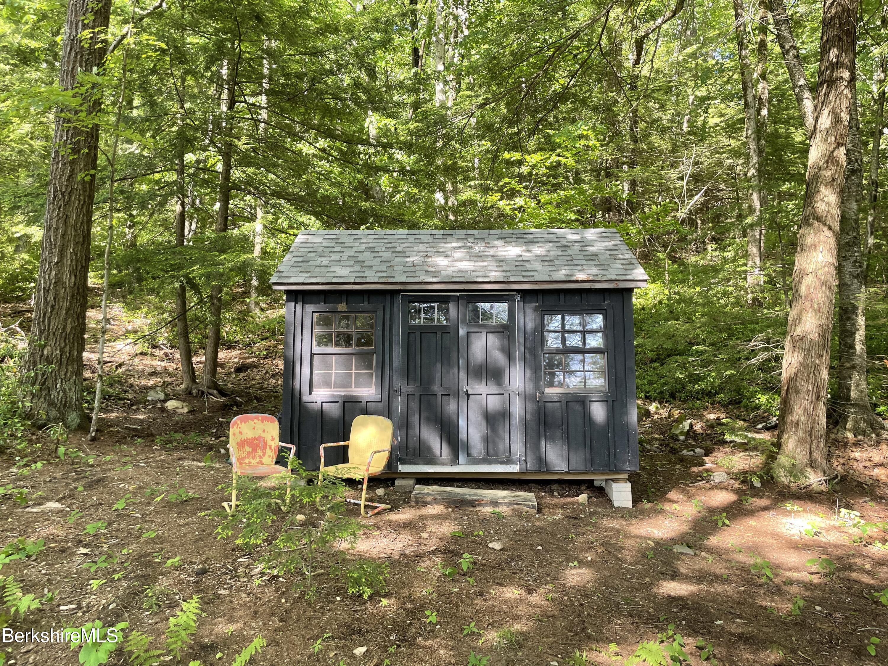 36 Elephant Rock Road Monterey, MA 01245 - Photo 27 of 30 a backyard of a house with table and chairs