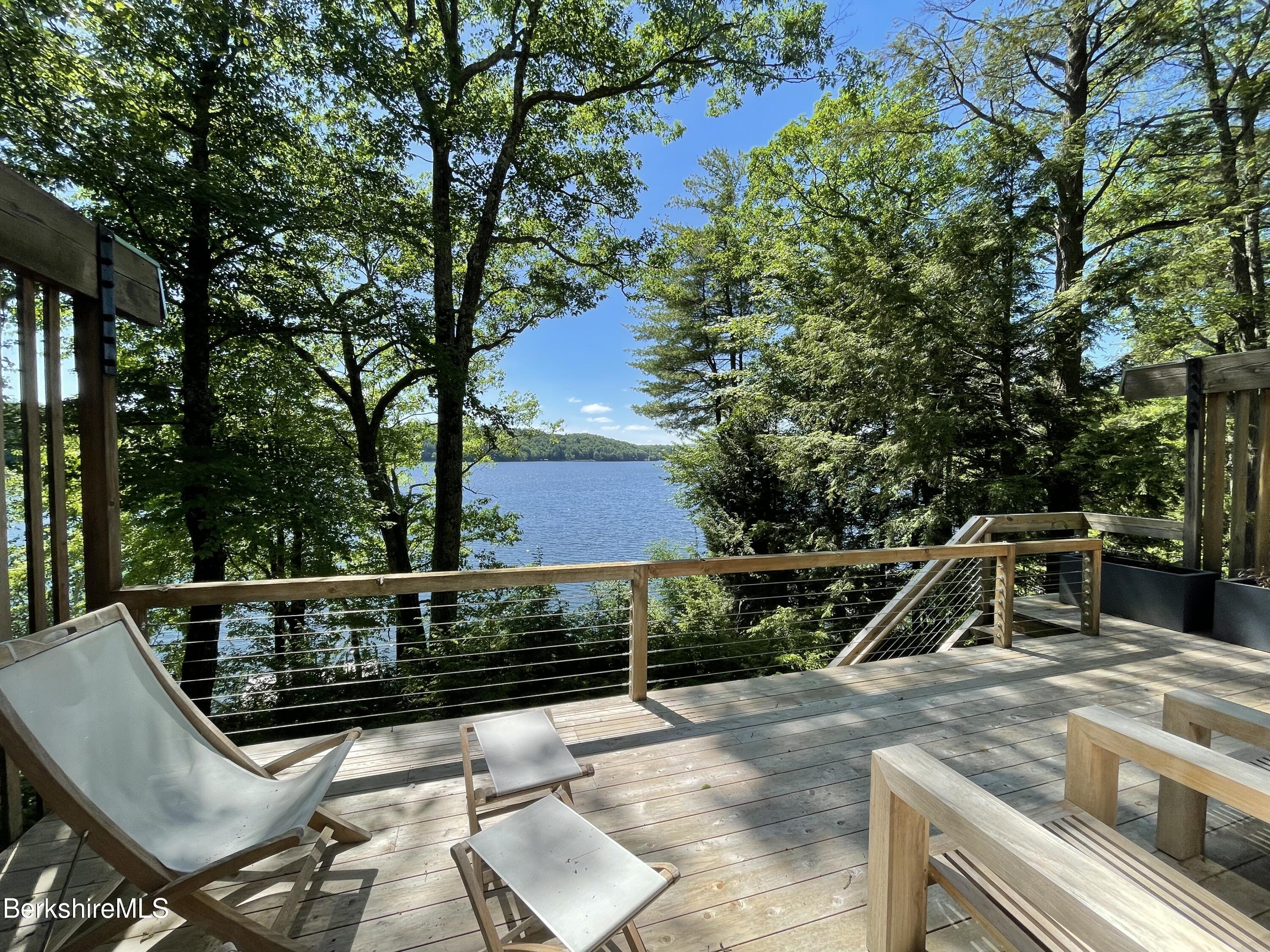 36 Elephant Rock Road Monterey, MA 01245 - Photo 6 of 30 a view of a roof deck with wooden fence and a couple of chairs