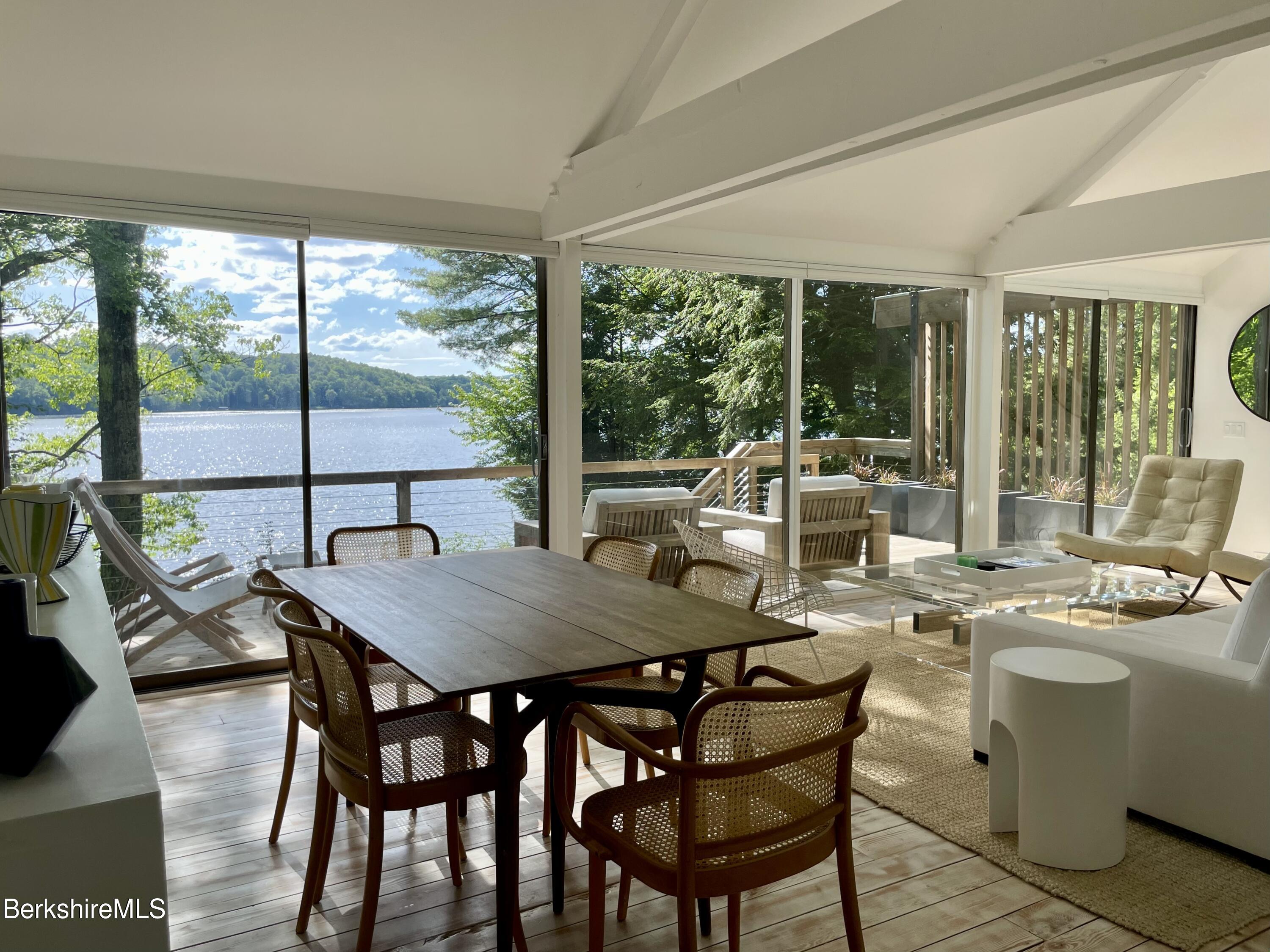 36 Elephant Rock Road Monterey, MA 01245 - Photo 9 of 30 a view of a dining room with furniture large windows and wooden floor