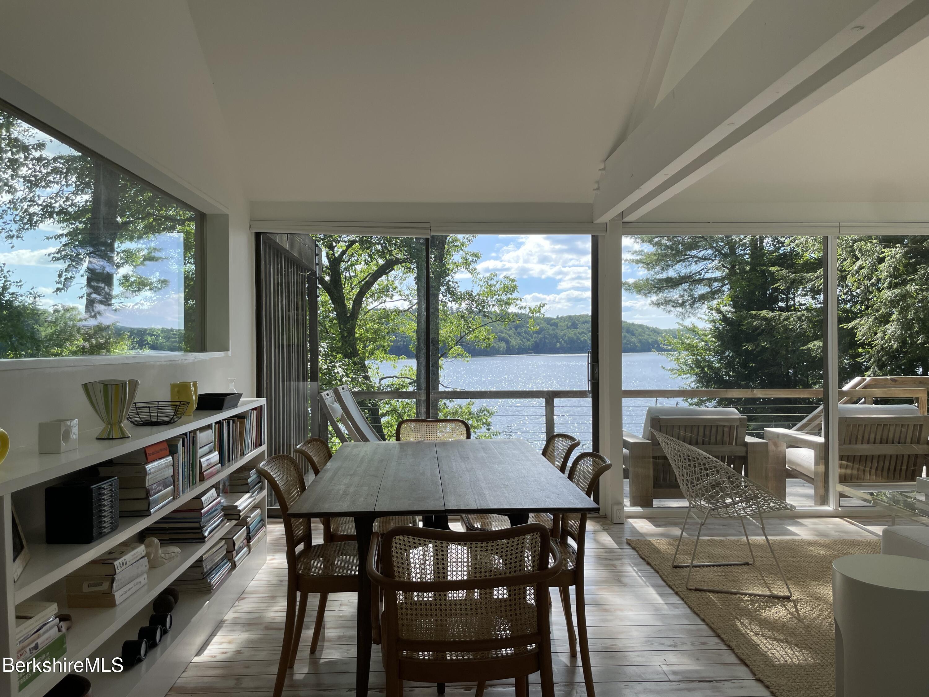 36 Elephant Rock Road Monterey, MA 01245 - Photo 10 of 30 a view of a dining room with furniture large windows and wooden floor