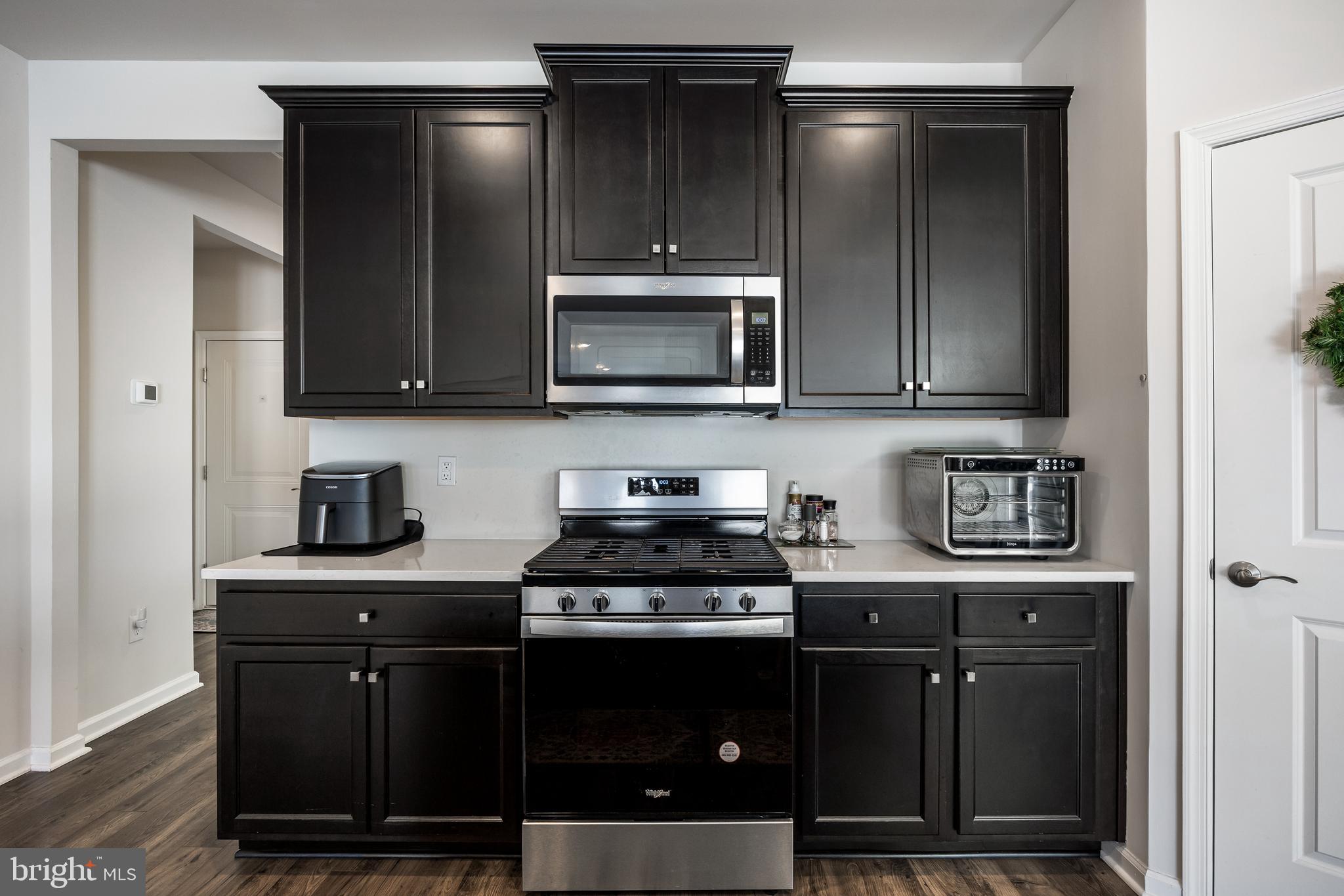 15 Walton Way Delanco, NJ 08075 - Photo 9 of 33 a kitchen with stainless steel appliances granite countertop a stove a microwave and cabinets