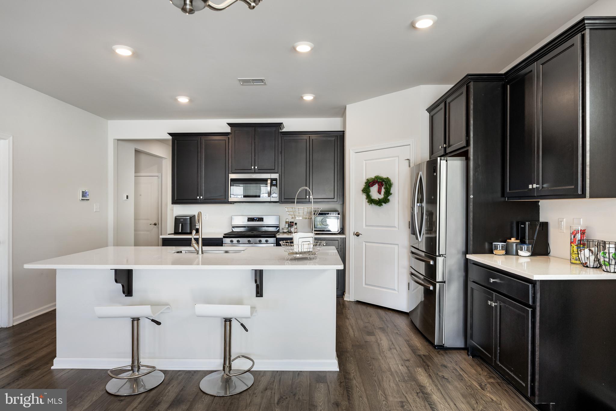 15 Walton Way Delanco, NJ 08075 - Photo 10 of 33 a kitchen with stainless steel appliances granite countertop a refrigerator a stove top oven a sink dishwasher and white cabinets with wooden floor