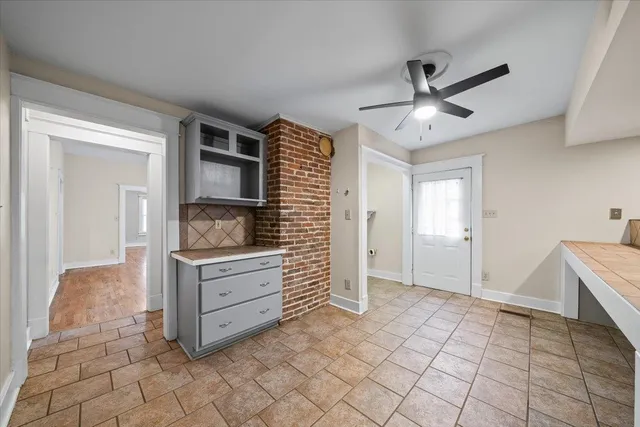 a room with a dresser and a window