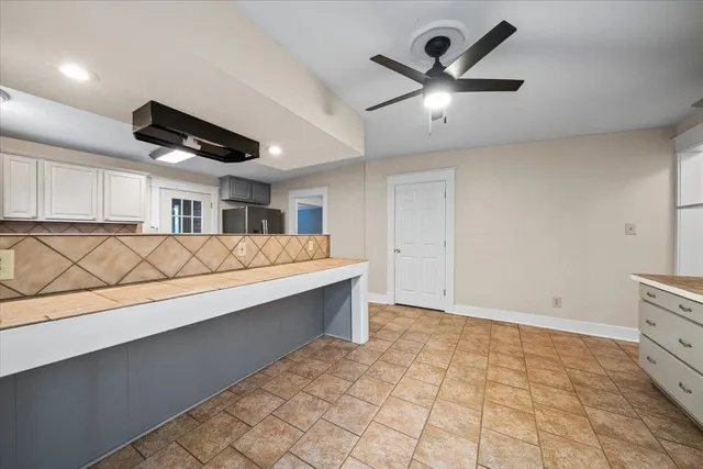 a kitchen with stainless steel appliances granite countertop a stove sink and cabinets