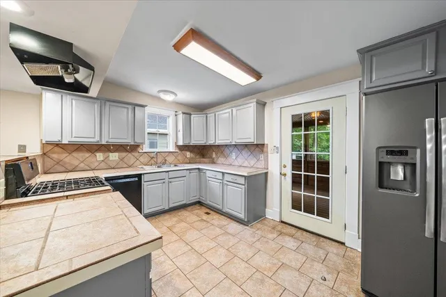 a kitchen with a sink stove and cabinets