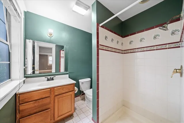 a bathroom with a sink toilet and window