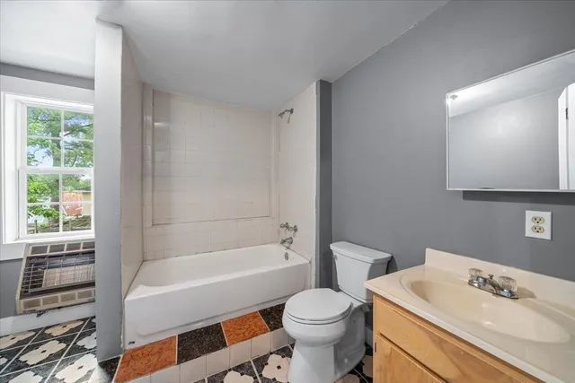 a view of a kitchen with a sink a stove and windows