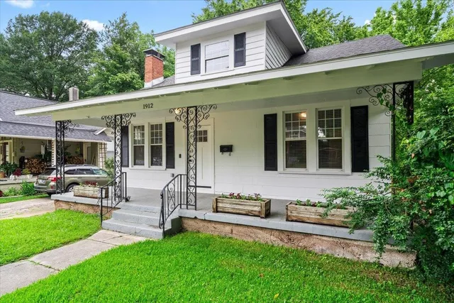 a view of a house with a backyard patio and sitting area