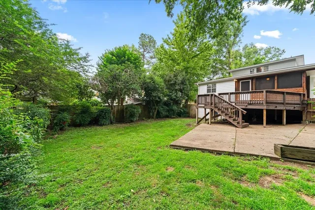 an outdoor view of house with backyard space and garden