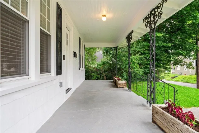 a view of a porch with furniture and a yard