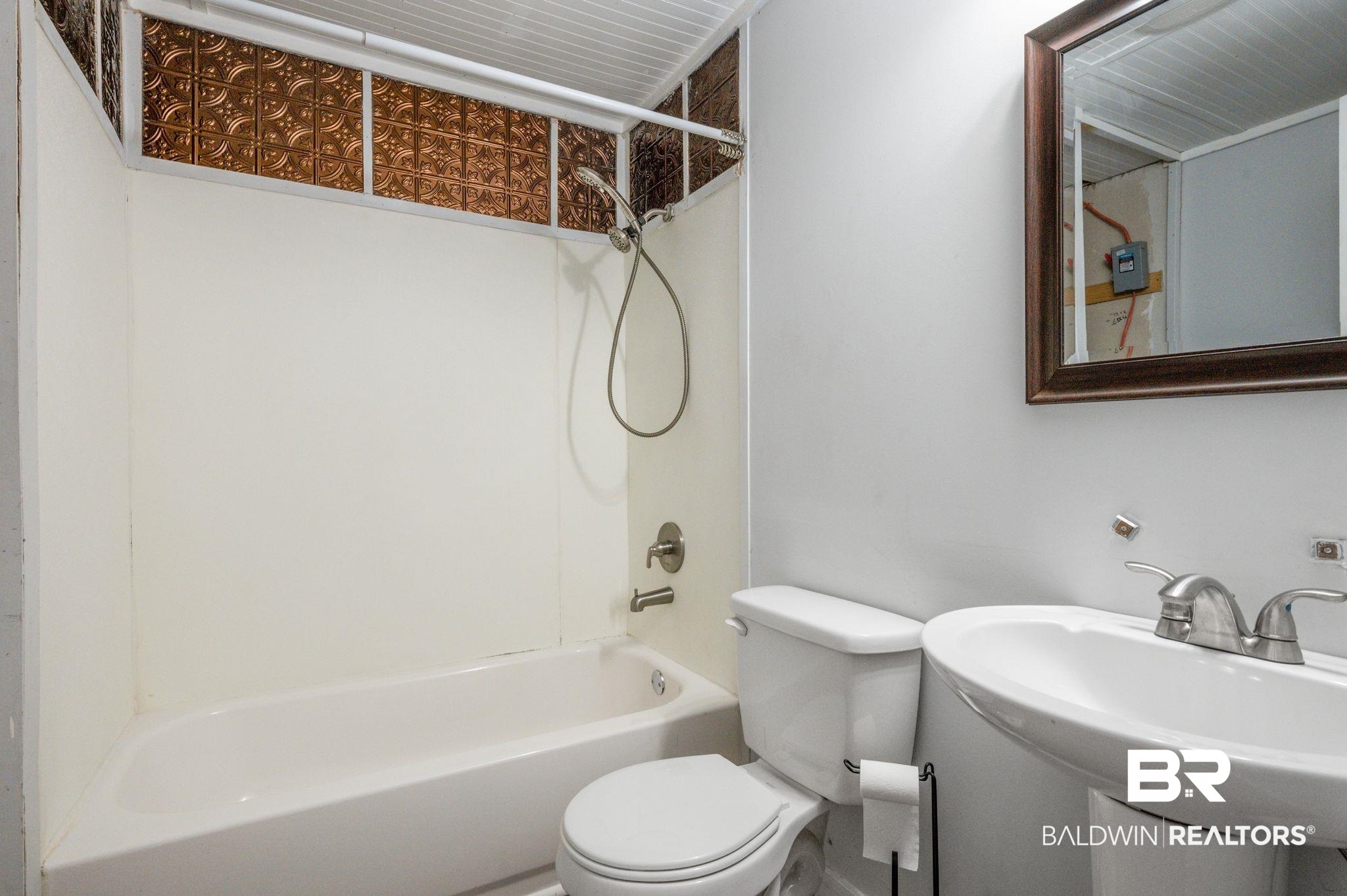 503 North Holly Street Foley, AL 36535 - Photo 21 of 23 Full bathroom featuring bathtub / shower combination, sink, and toilet