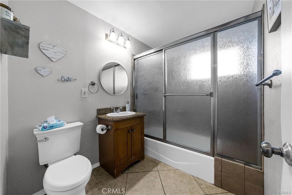6220 Filkins Avenue Rancho Cucamonga, CA 91737 - Photo 13 of 16 a white toilet sitting next to a bathroom sink