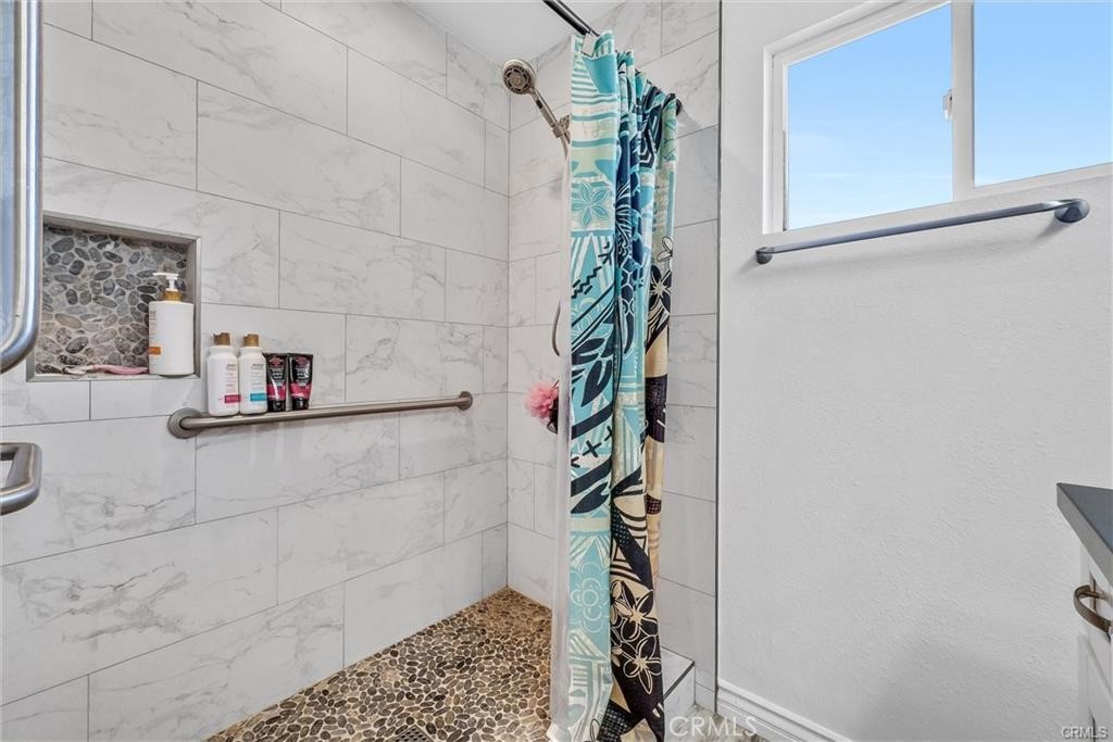 6220 Filkins Avenue Rancho Cucamonga, CA 91737 - Photo 15 of 16 a bathroom with a shower and a sink