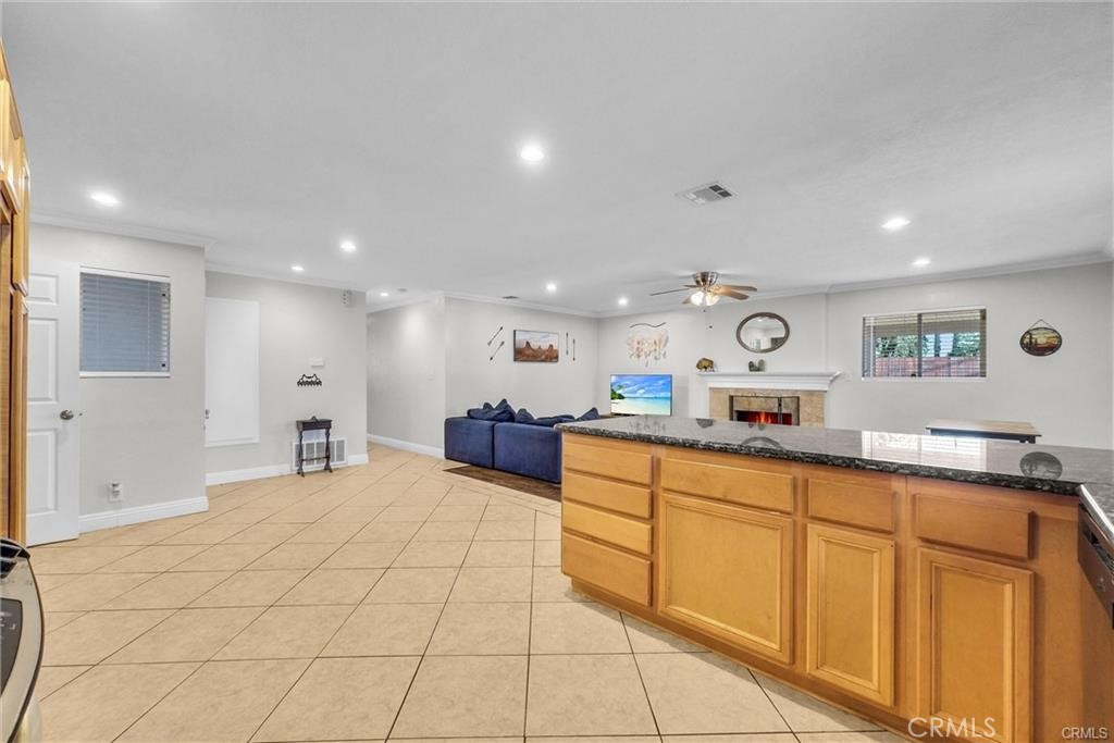 6220 Filkins Avenue Rancho Cucamonga, CA 91737 - Photo 8 of 16 a large white room with stainless steel appliances kitchen island granite countertop a sink and cabinets