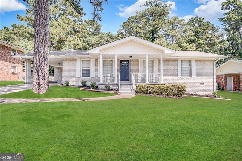 1914 Janet Lane Decatur, GA 30035 - Photo 1 of 1 a front view of a house with a garden and trees