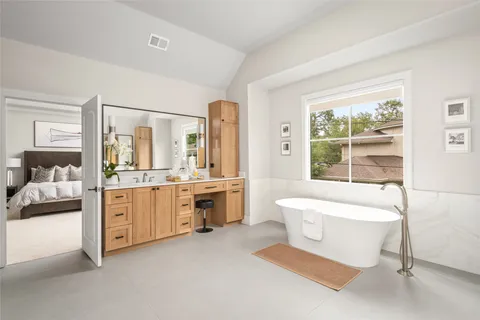 a bathroom with a tub sink and mirror