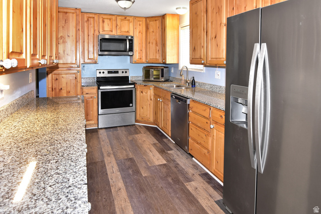 315 Park Street Inkom, ID 83245 - Photo 7 of 28 Kitchen featuring light wood cabinetry, granite countertops, stainless steel appliances, and wood-finish flooring
