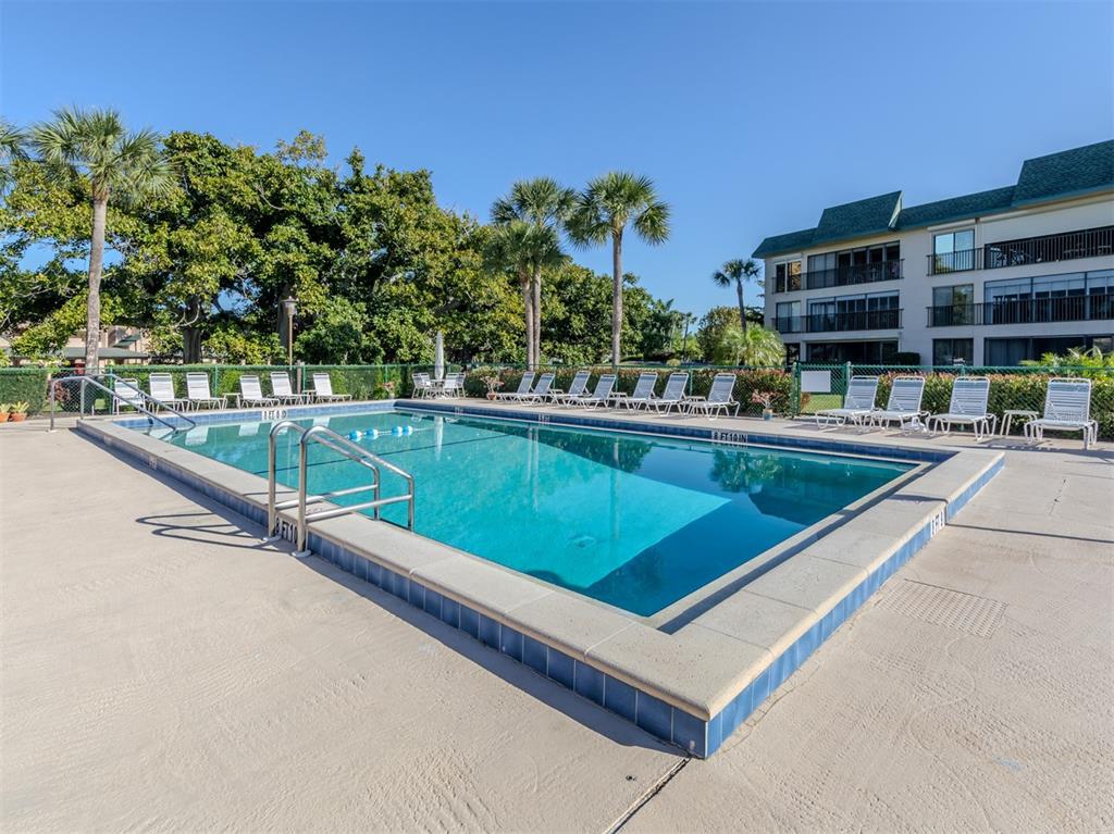 601 Shreve Street, Unit 51B Punta Gorda, FL 33950 - Photo 40 of 43 a view of a pool with a bench in front of it