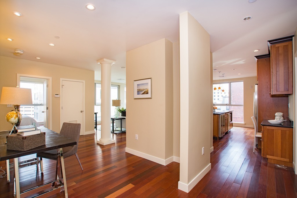 99-105 Broad Street, Unit 8C Boston, MA 02110 - Photo 14 of 28 a view of a dining room with furniture and wooden floor
