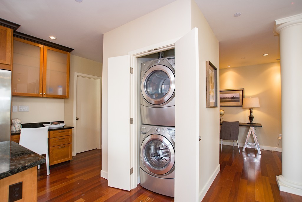 99-105 Broad Street, Unit 8C Boston, MA 02110 - Photo 17 of 28 a view of a kitchen with washer and dryer