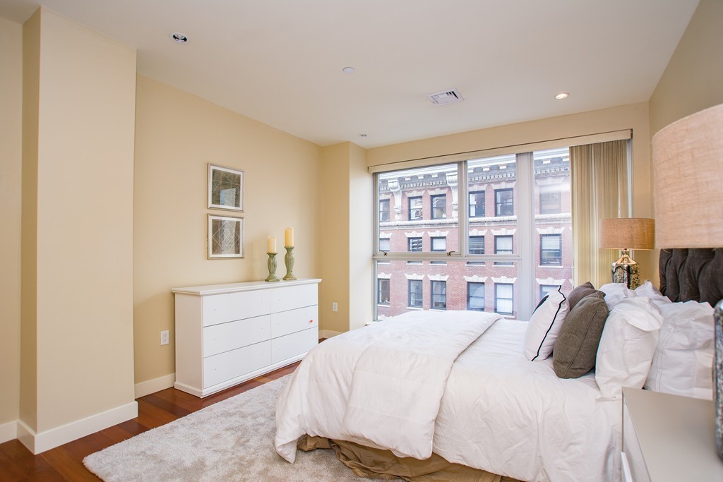 99-105 Broad Street, Unit 8C Boston, MA 02110 - Photo 21 of 28 a bedroom with a bed and a cabinets