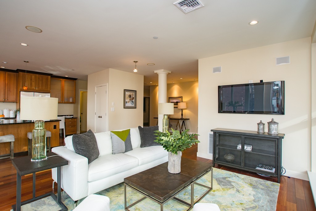 99-105 Broad Street, Unit 8C Boston, MA 02110 - Photo 24 of 28 a living room with furniture and a flat screen tv