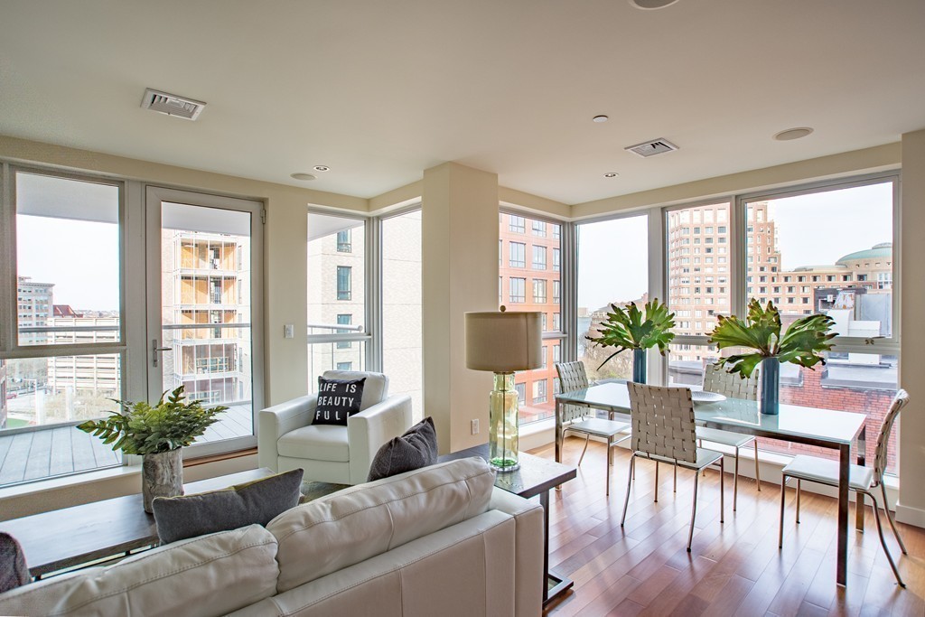 99-105 Broad Street, Unit 8C Boston, MA 02110 - Photo 28 of 28 a living room with furniture potted plant and windows
