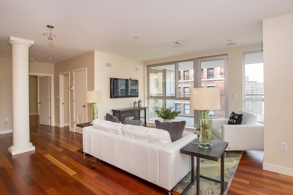 99-105 Broad Street, Unit 8C Boston, MA 02110 - Photo 6 of 28 a living room with furniture and a wooden floor