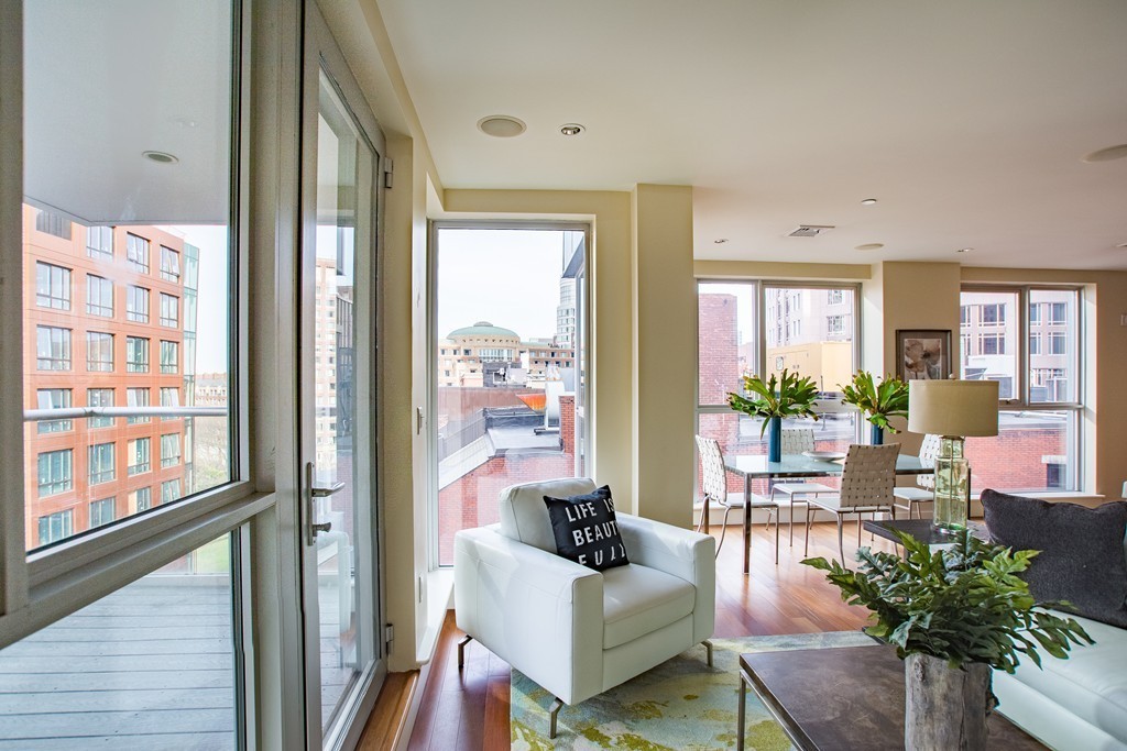 99-105 Broad Street, Unit 8C Boston, MA 02110 - Photo 7 of 28 a living room with furniture and a floor to ceiling window