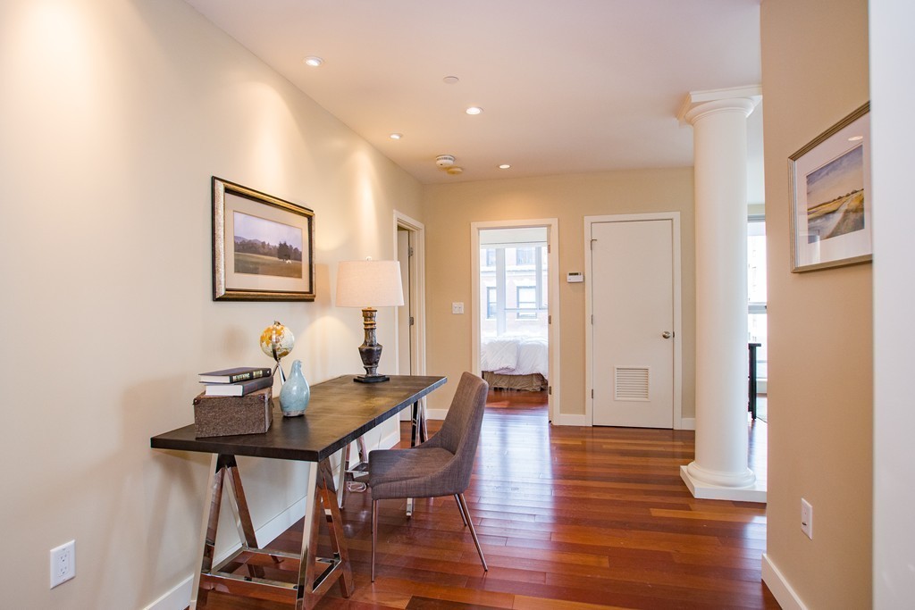 99-105 Broad Street, Unit 8C Boston, MA 02110 - Photo 8 of 28 a view of a dining room with furniture and wooden floor